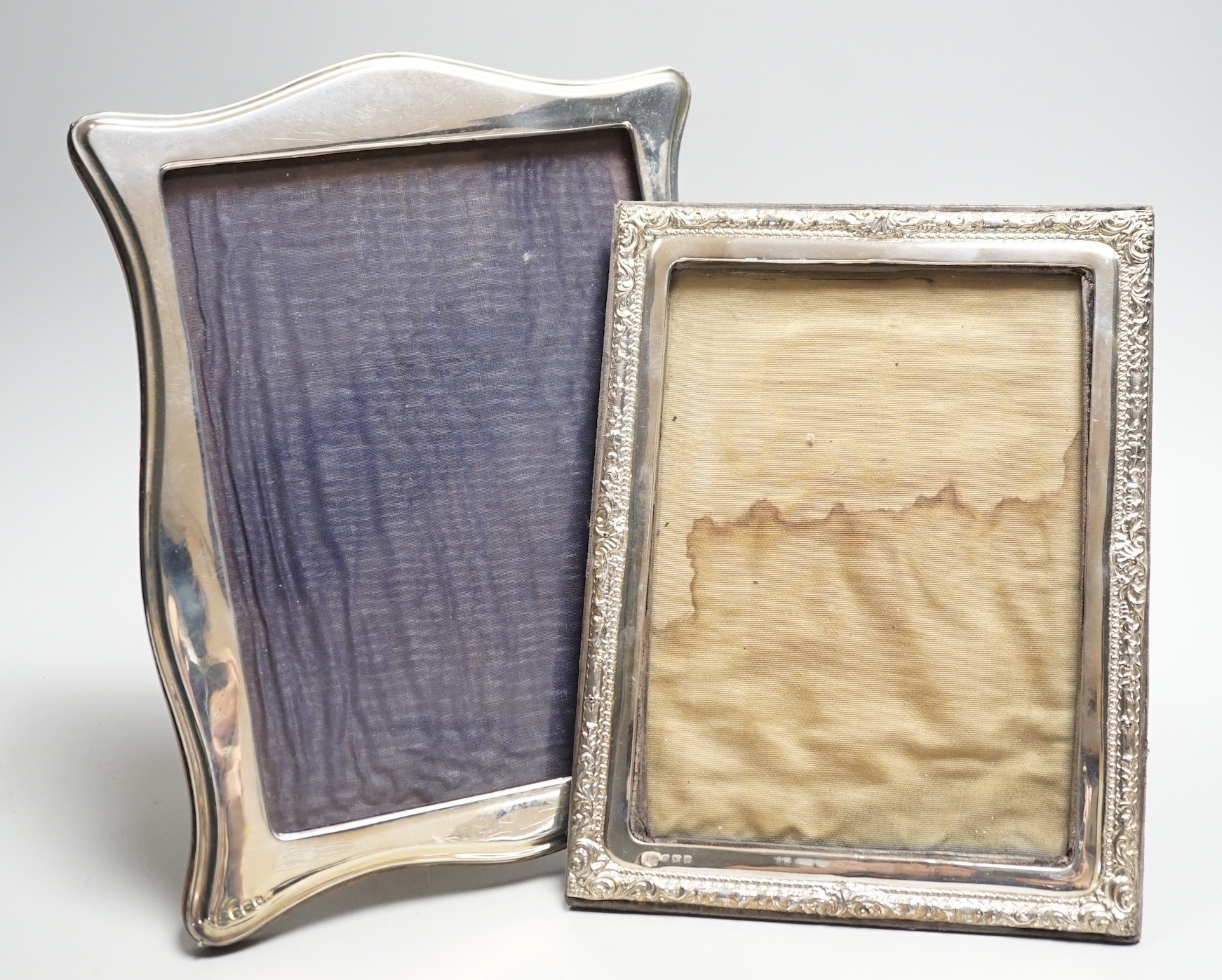 Two silver mounted photograph frames, including Edwardian with repousse border, Birmingham, 1909, 22.2cm.